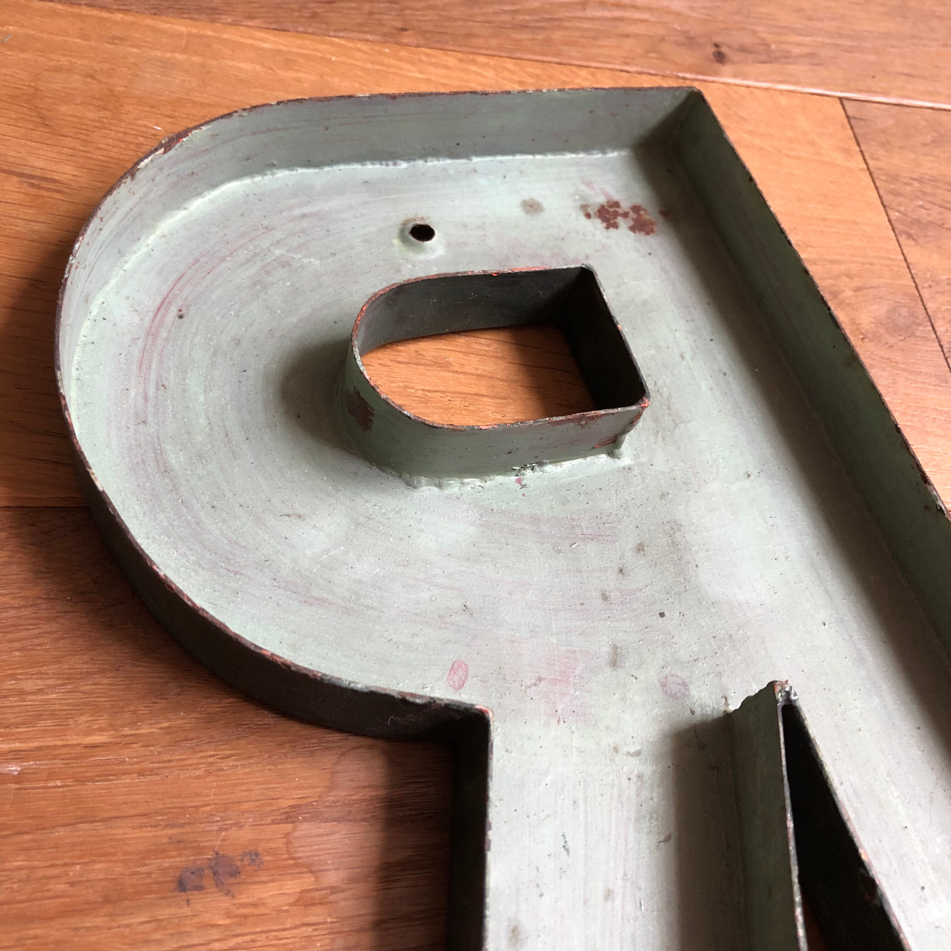 Ancient letter r sign metal painted