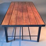 Vintage modernist coffee table in teak and black metal.