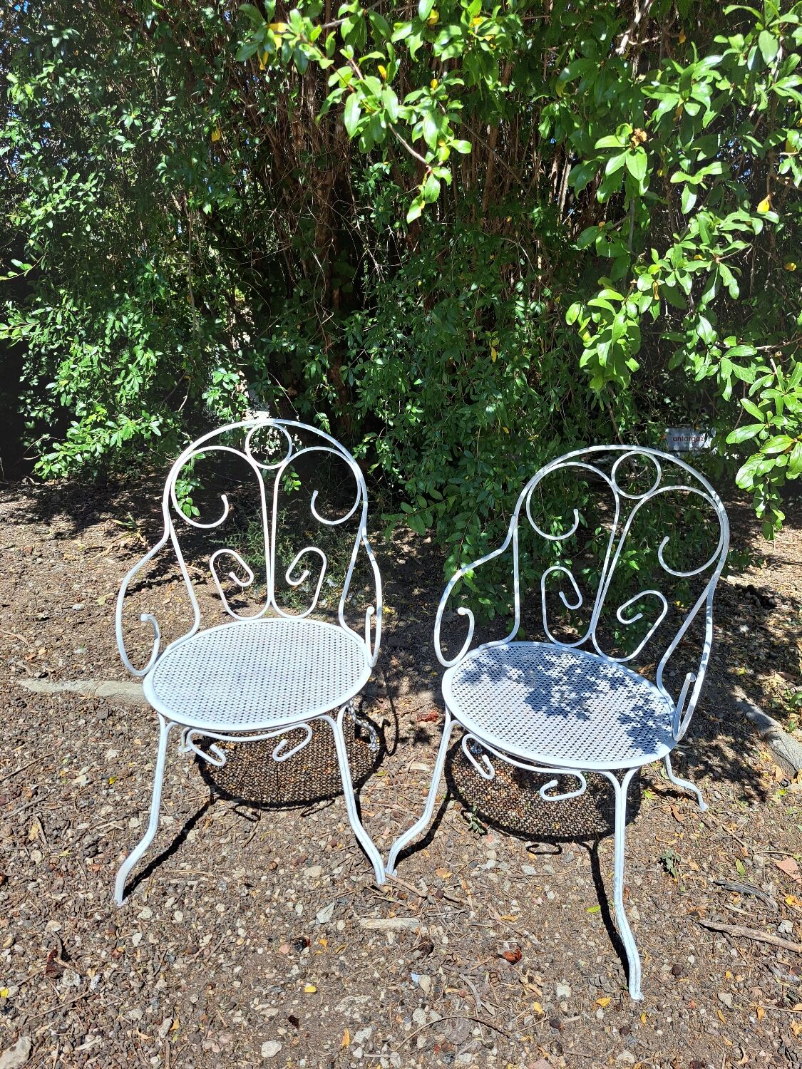 Pair of old white iron armchairs