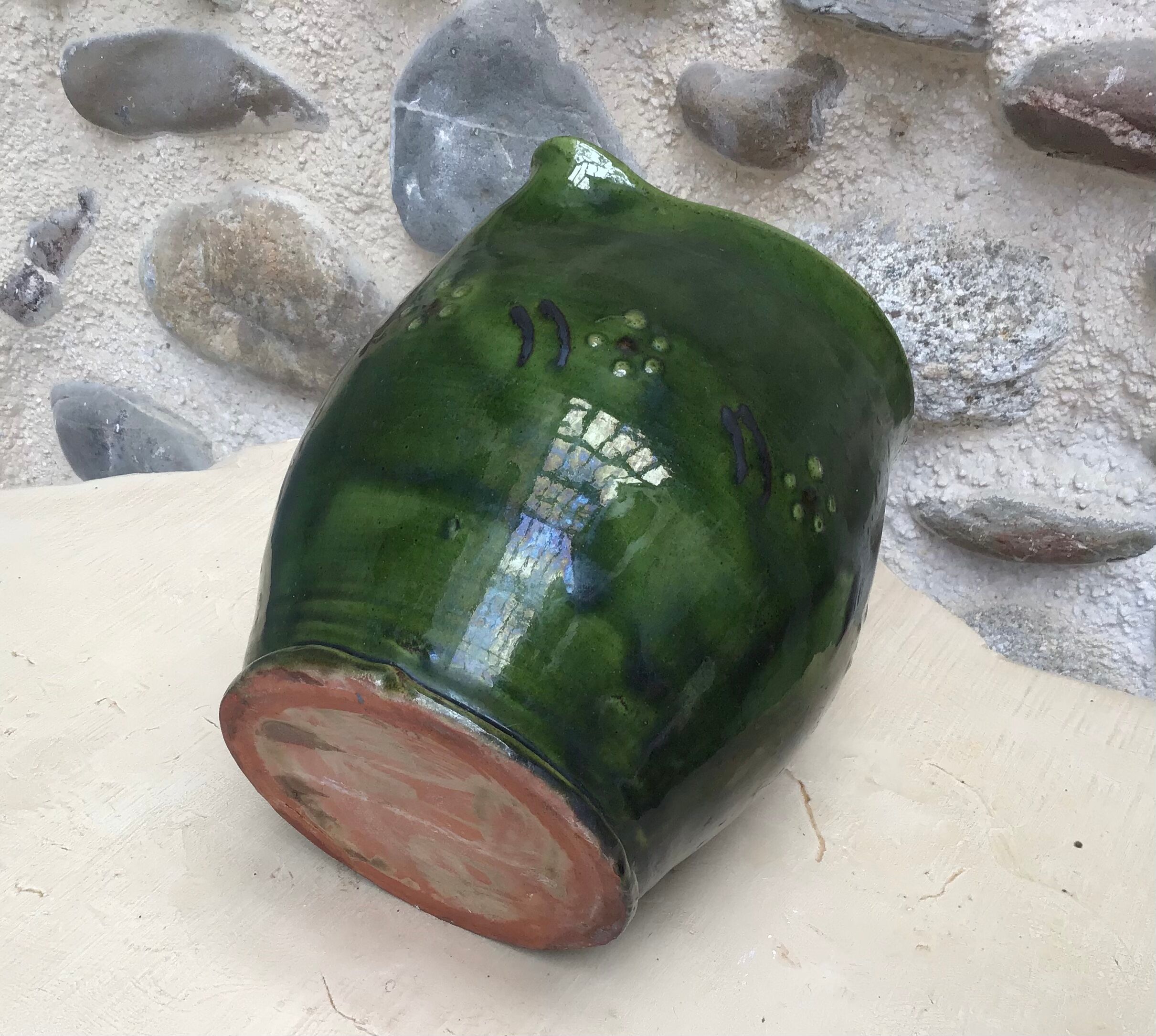 Green varnished earth pitcher with flower pattern