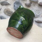 Green varnished earth pitcher with flower pattern