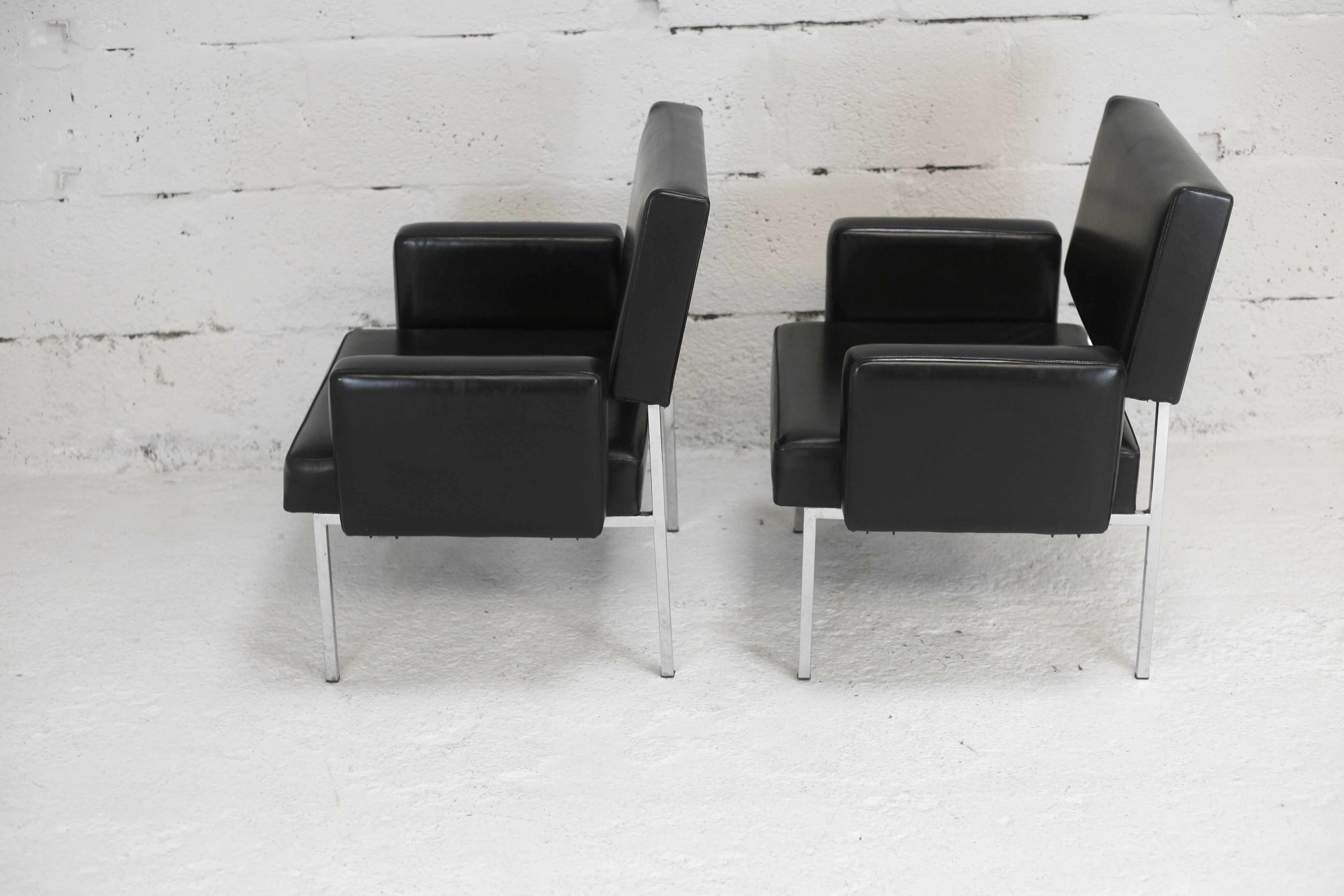 Pair of stainless steel, black leather-like armchairs, France, circa 1970