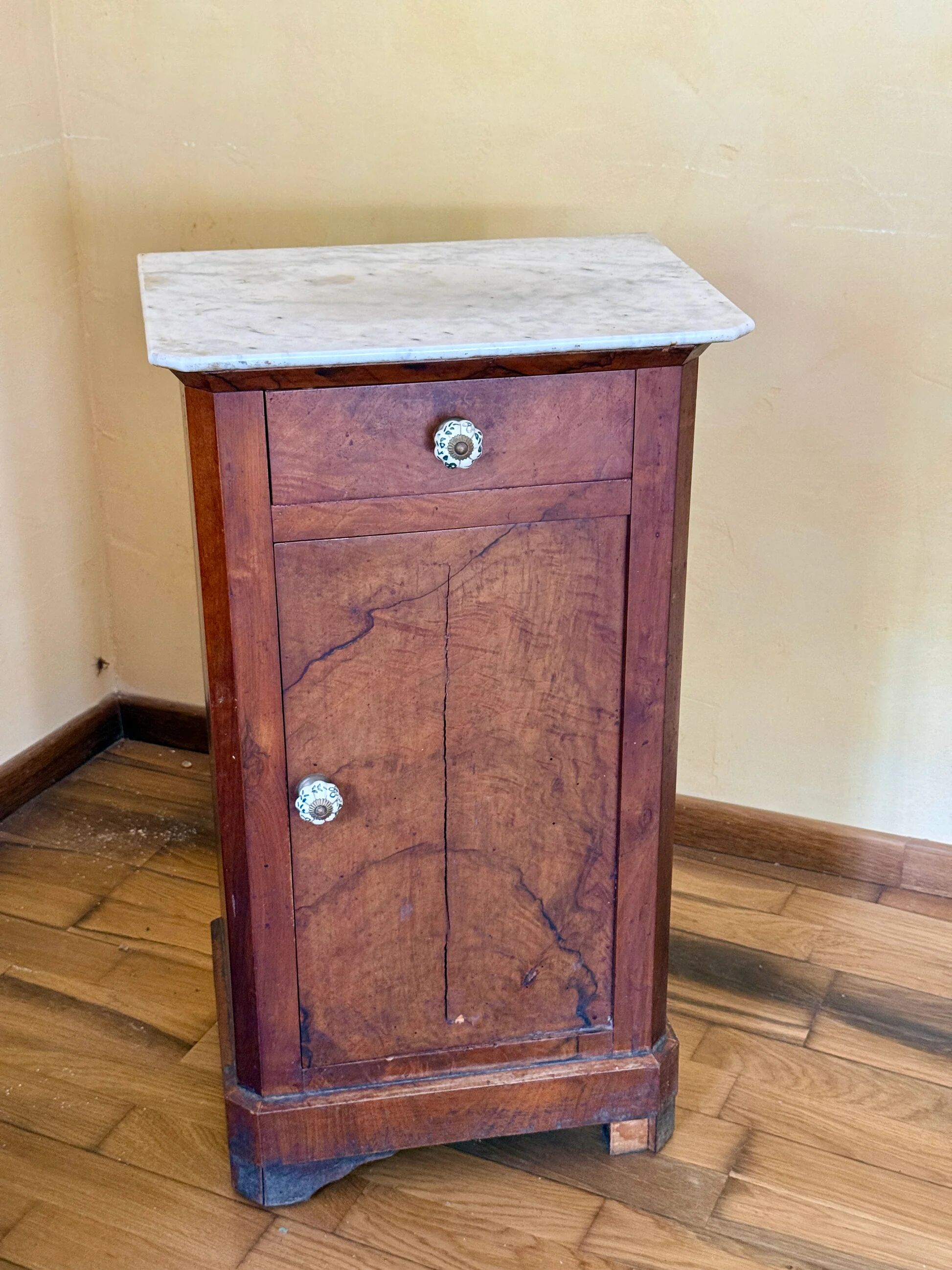 Wood and marble side table with ceramic handles.