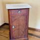 Wood and marble side table with ceramic handles.