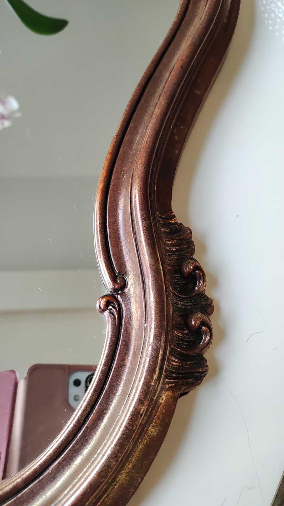 Pretty Baroque style mirror / Louis XV patinated with pink / golden copper reflections. Volutes, leafy shells