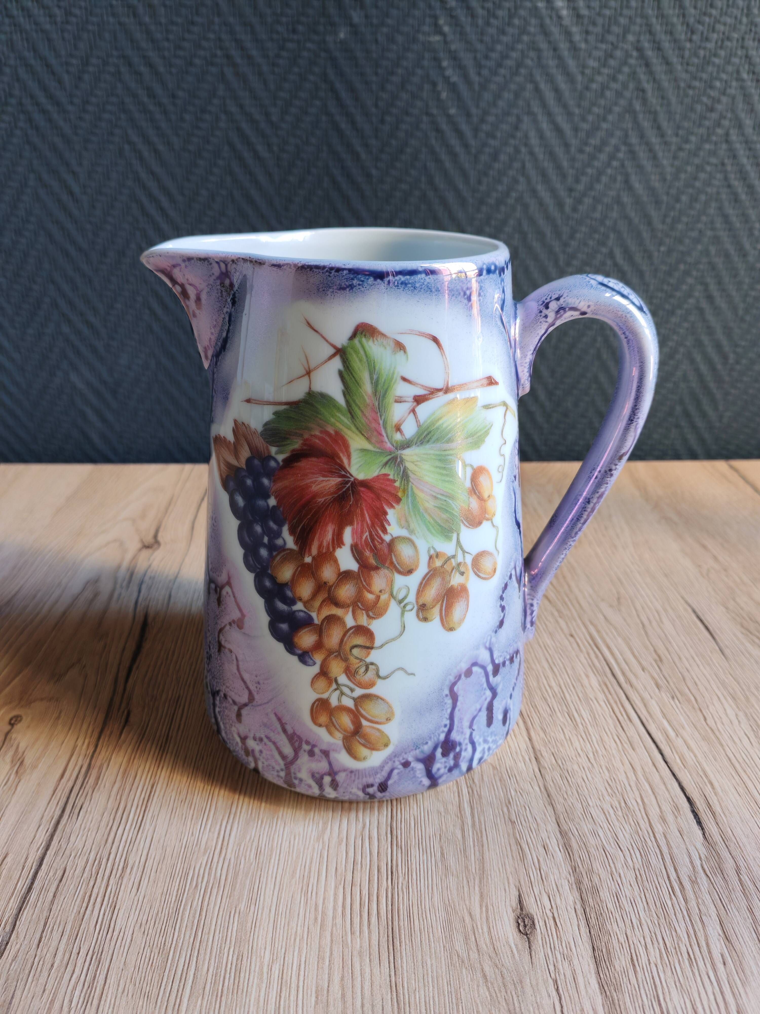 Vintage porcelain pitcher Lusseray France, decorated with grape clusters.