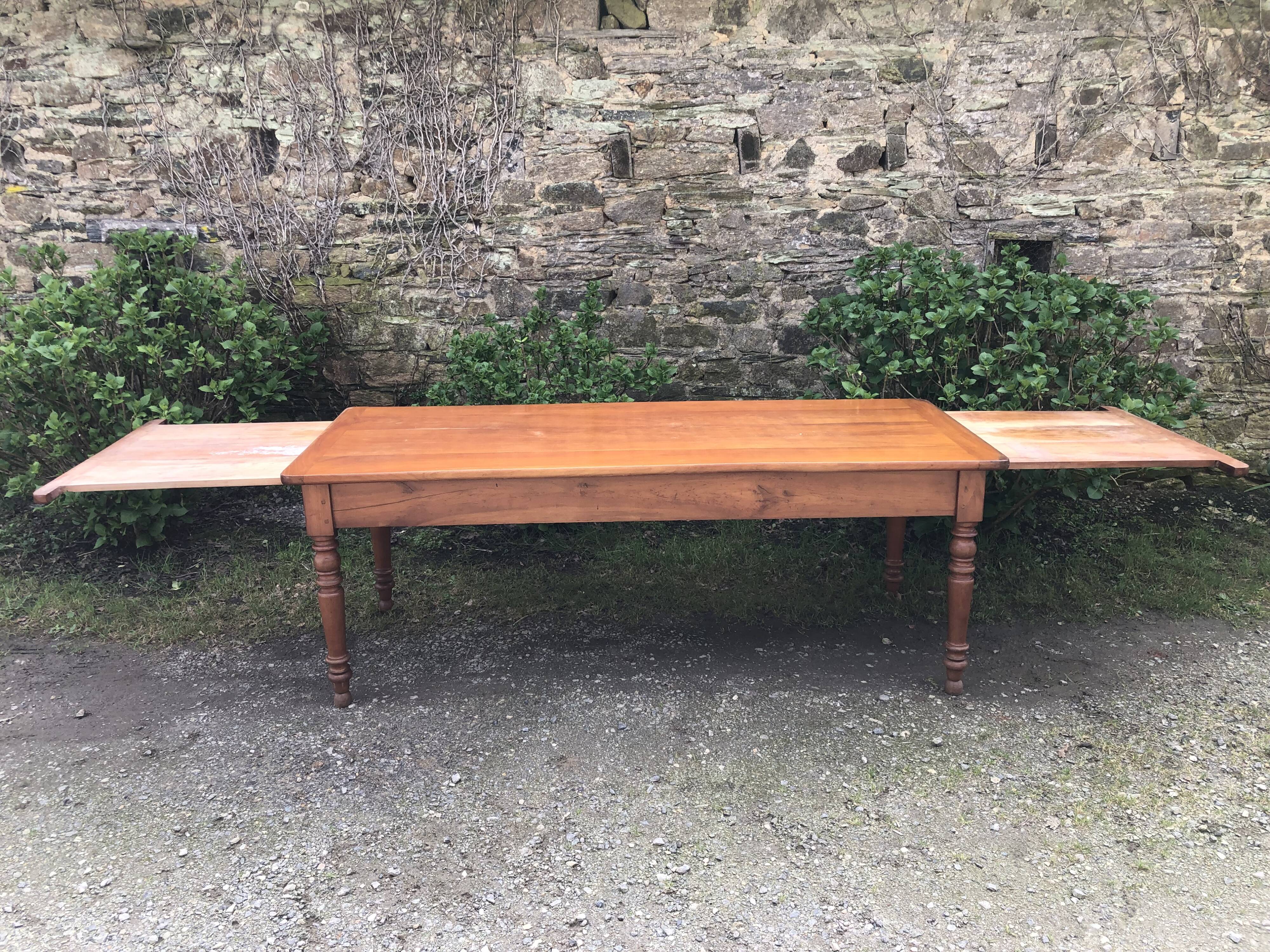 Antique Louis Philippe style farmhouse table in solid cherry wood with its 2 extensions.