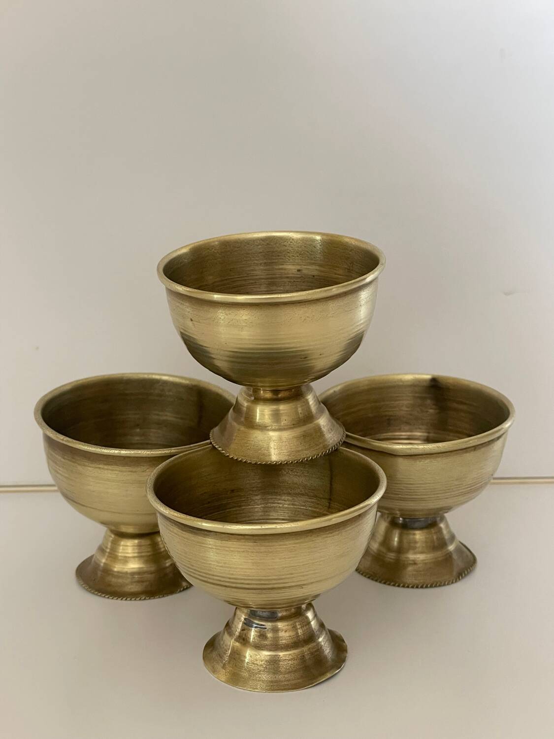 4 golden brass egg cups