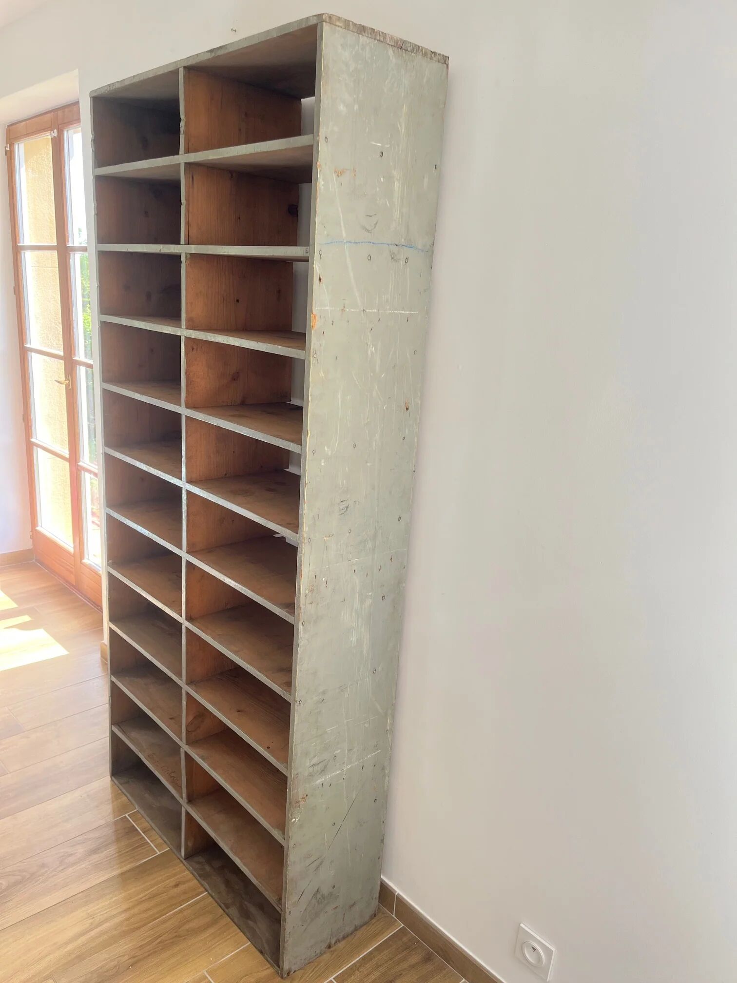 Large antique workshop cabinet with patinated wooden compartments, 20th century.