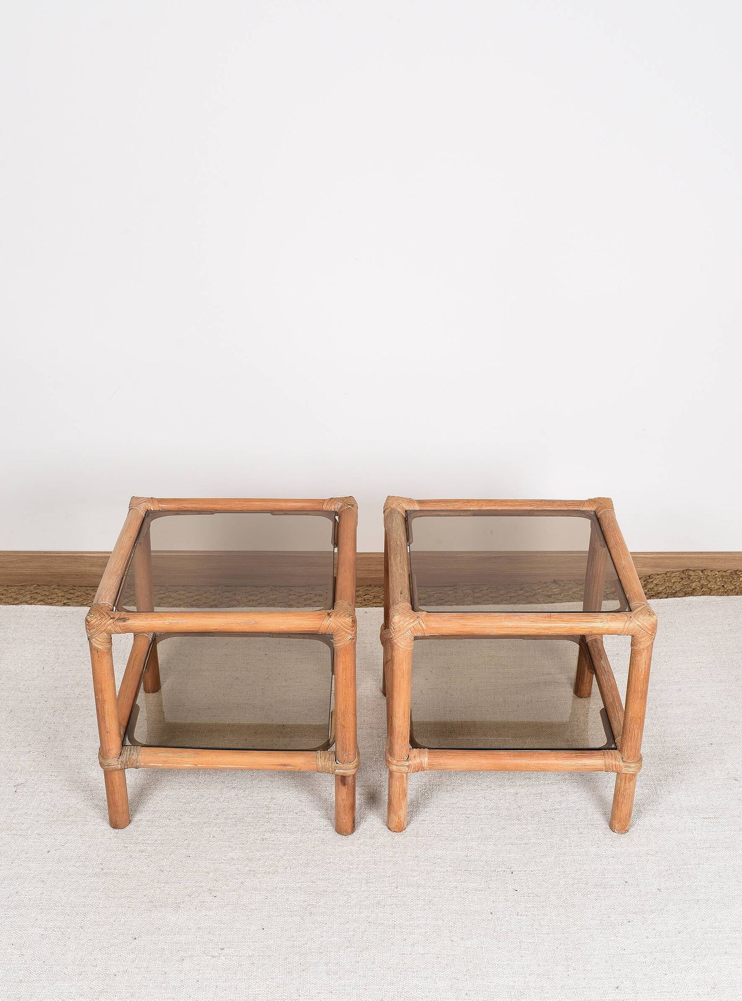 Pair of bedside tables or side tables, in rattan and smoked glass