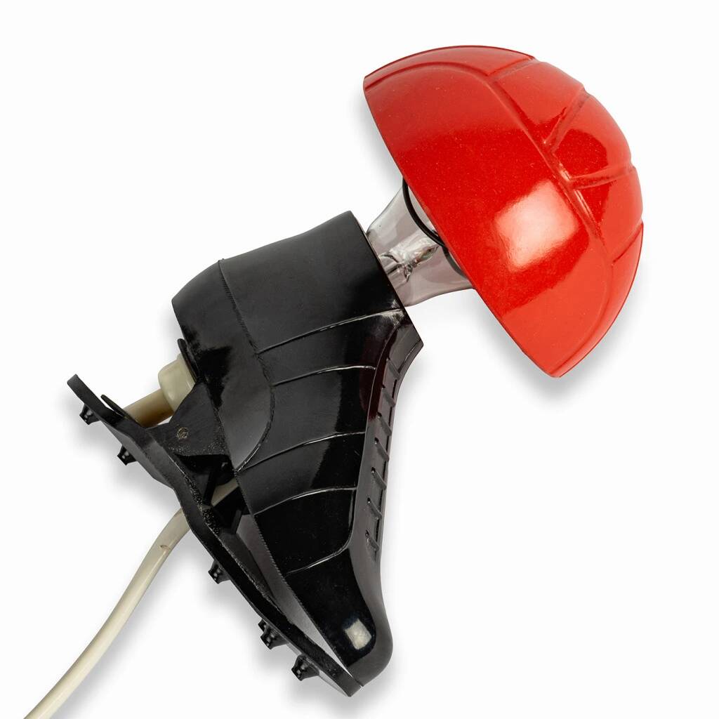 A small, wooden table lamp that stands on a tripod