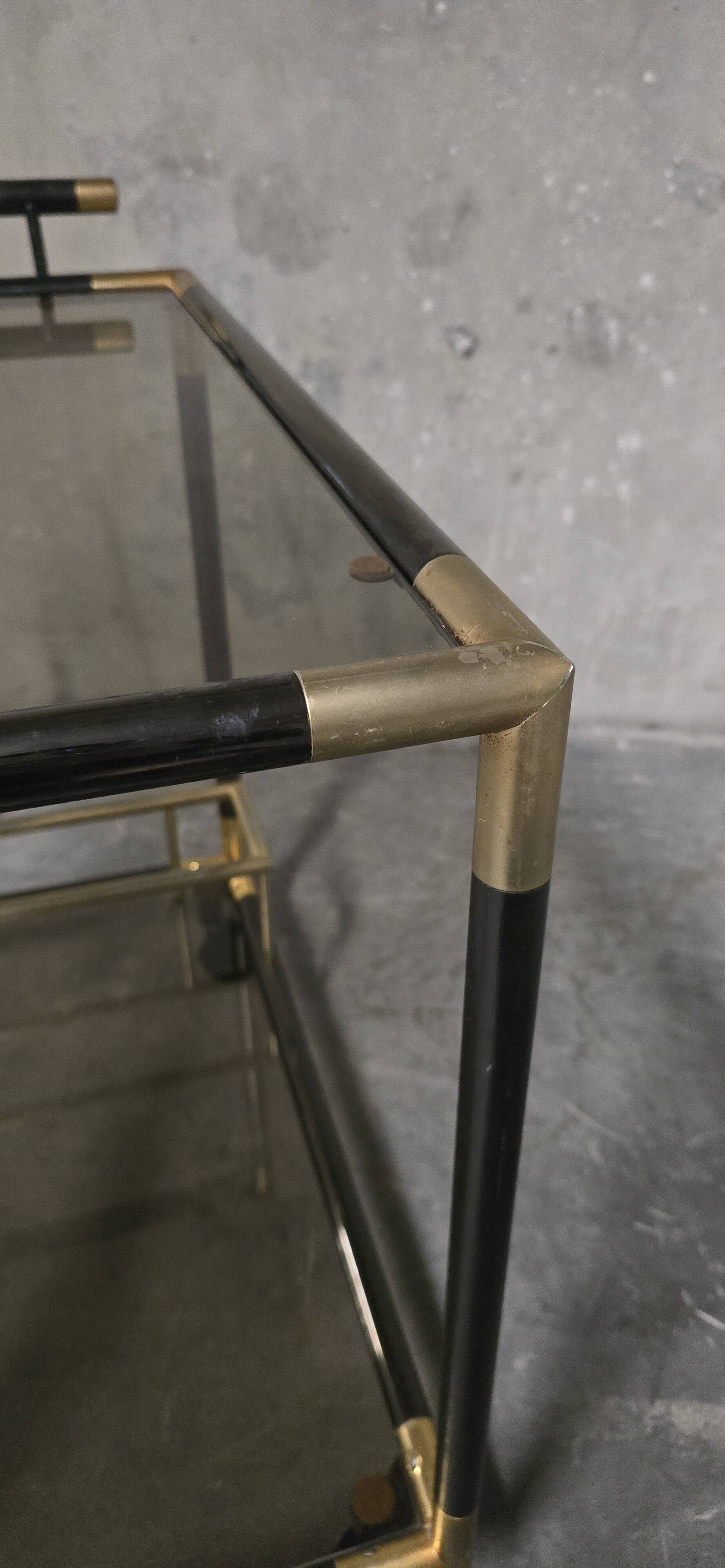 Black metal and brass rolling dessert trolley, smoked glass, 1970s.