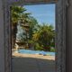 Chic and stylish old mirror with carved wooden frame in limed white and gold