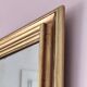 Miroir ancien en bois doré et cuivré
