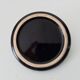 Vintage black ceramic candle holder on a bowl