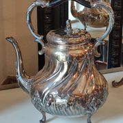 Ancient samovar tea fountain in silver metal