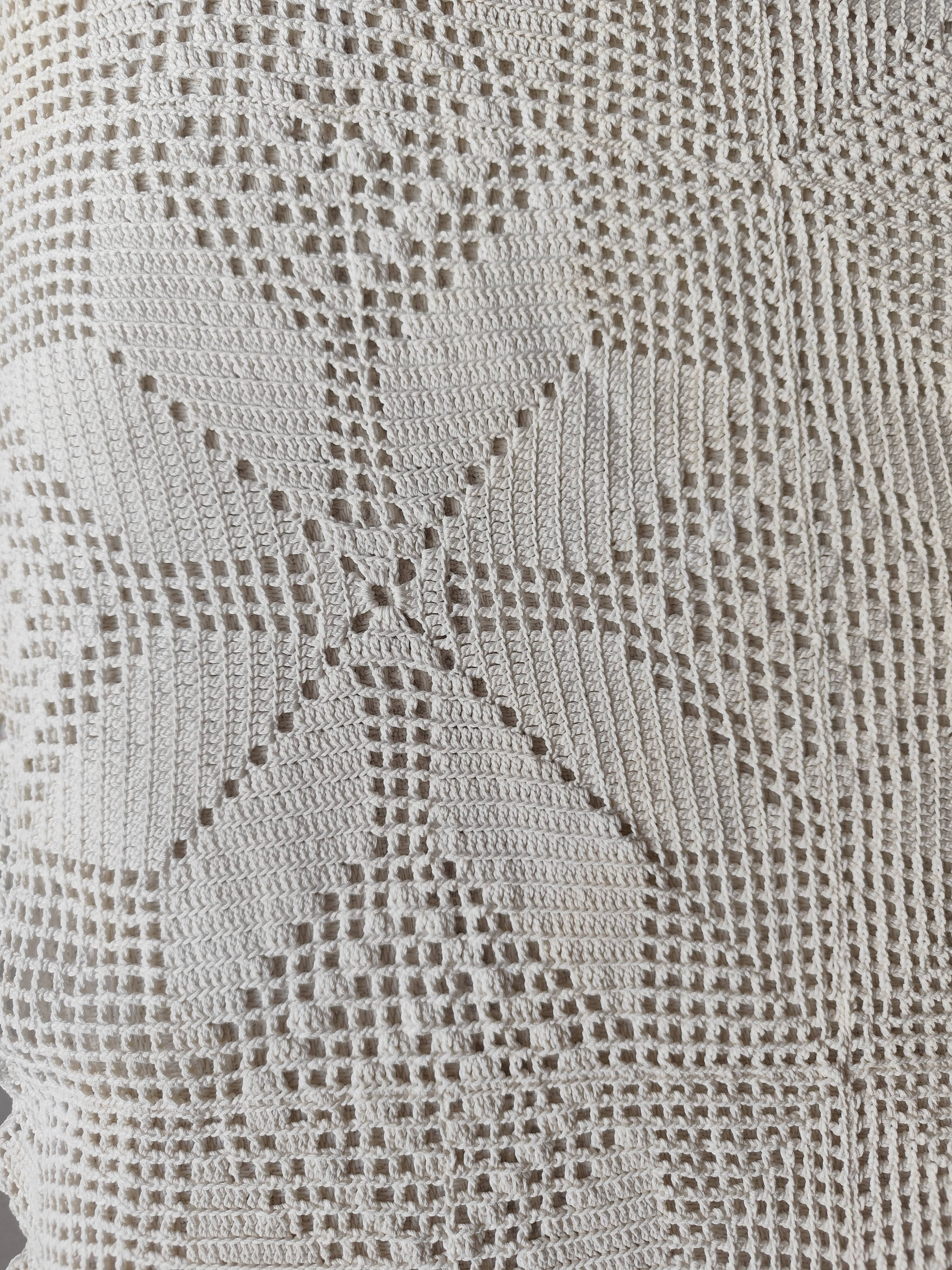 White cotton bedspread, crocheted sofa throw with star patterns