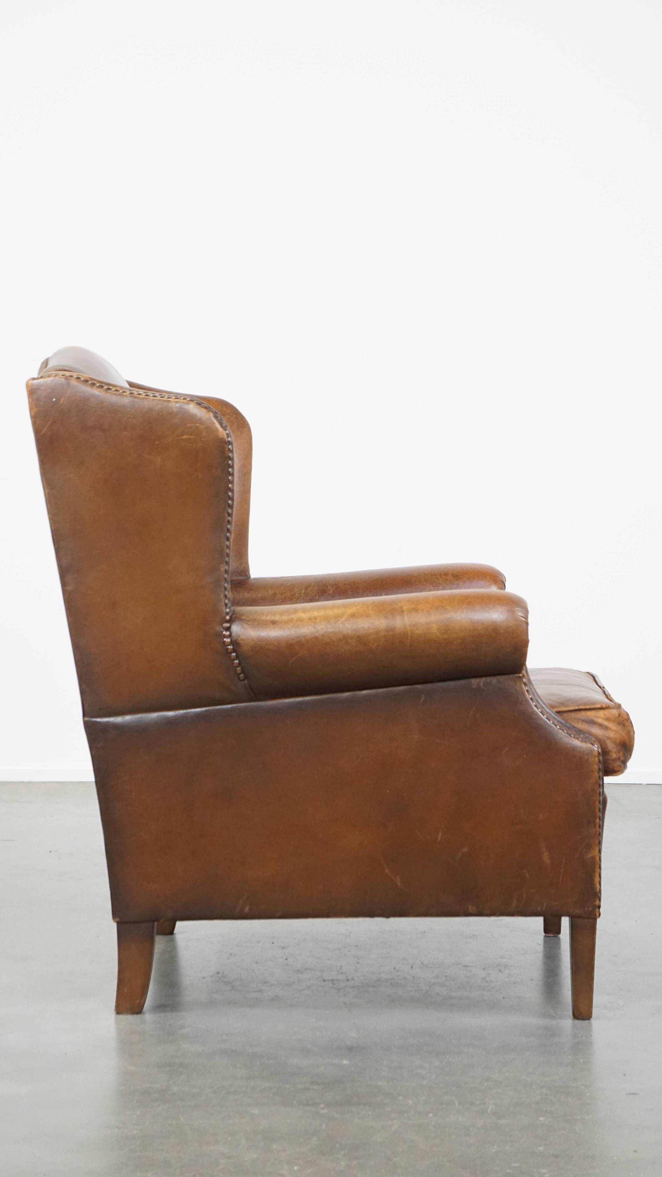 Cognac-colored sheepskin wing chair in English style