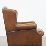 Cognac-colored sheepskin wing chair in English style