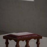Danish sculpted oak stool from the mid-20th century with a red leather seat, 1950s.
