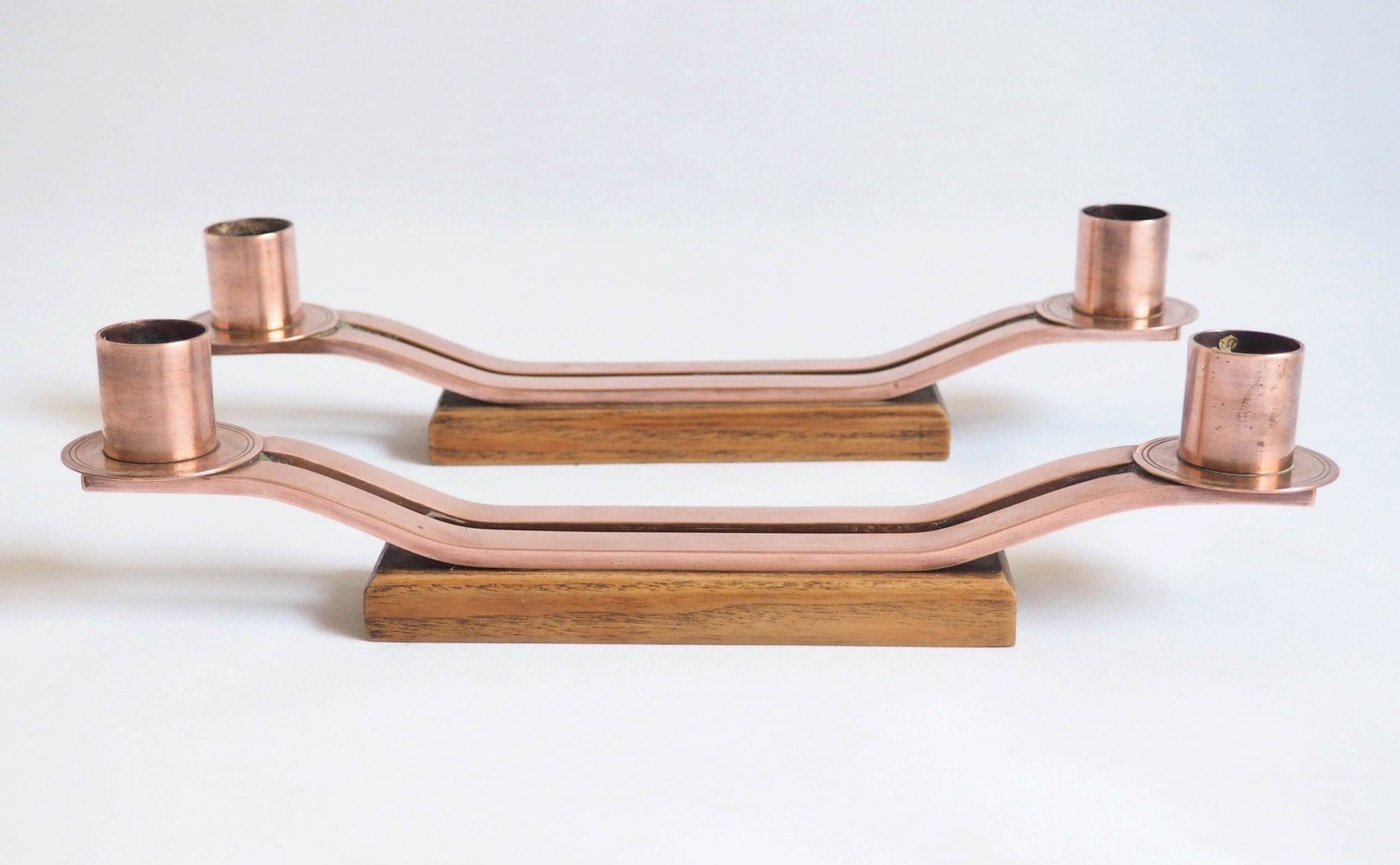 Pair of oak and copper bronze candlesticks