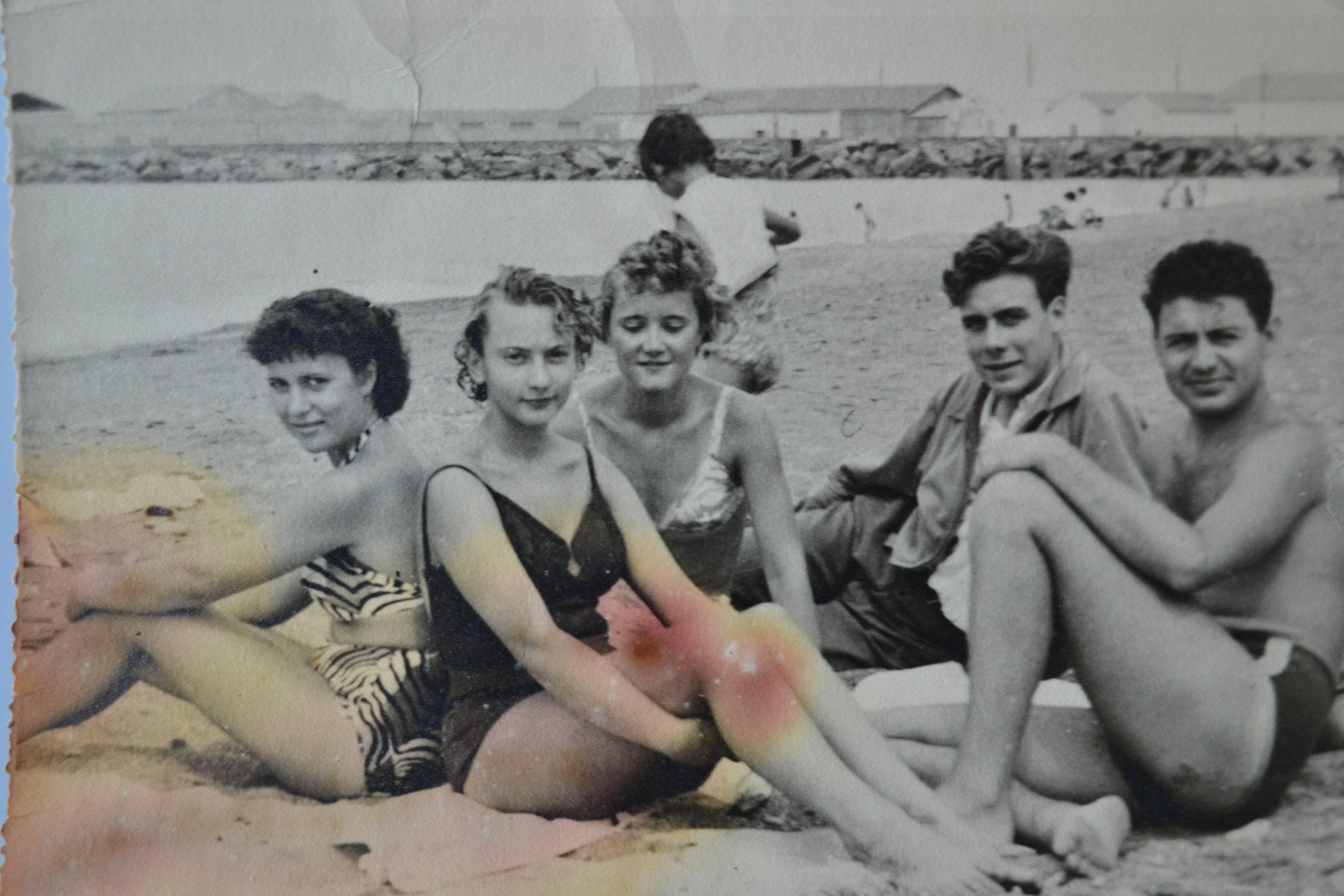Old film photo circa 1950 the beach group of teenagers