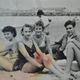 Old film photo circa 1950 the beach group of teenagers