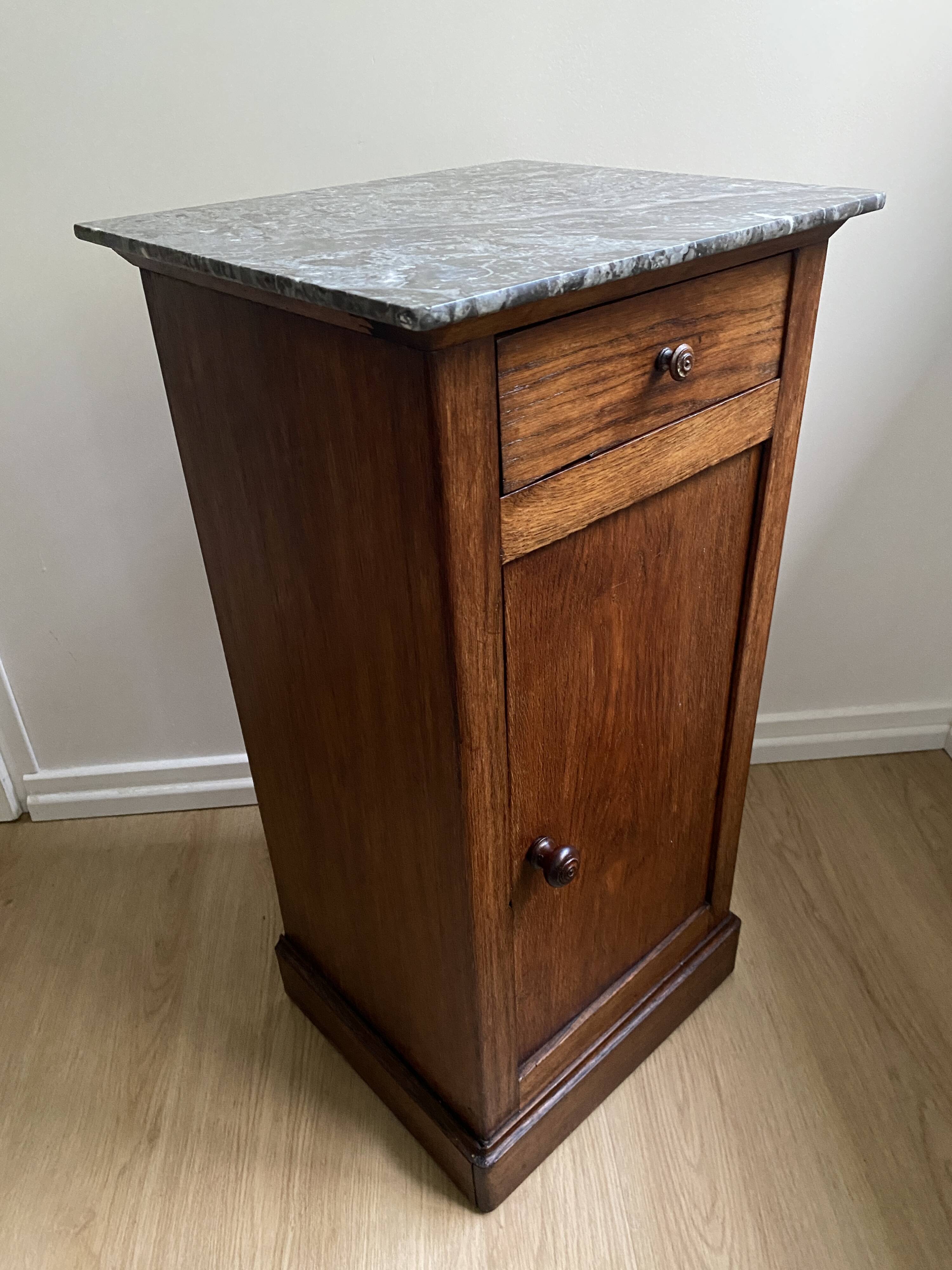 Vintage bedside table in the shape of a wooden column and a gray marble top