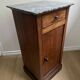 Vintage bedside table in the shape of a wooden column and a gray marble top