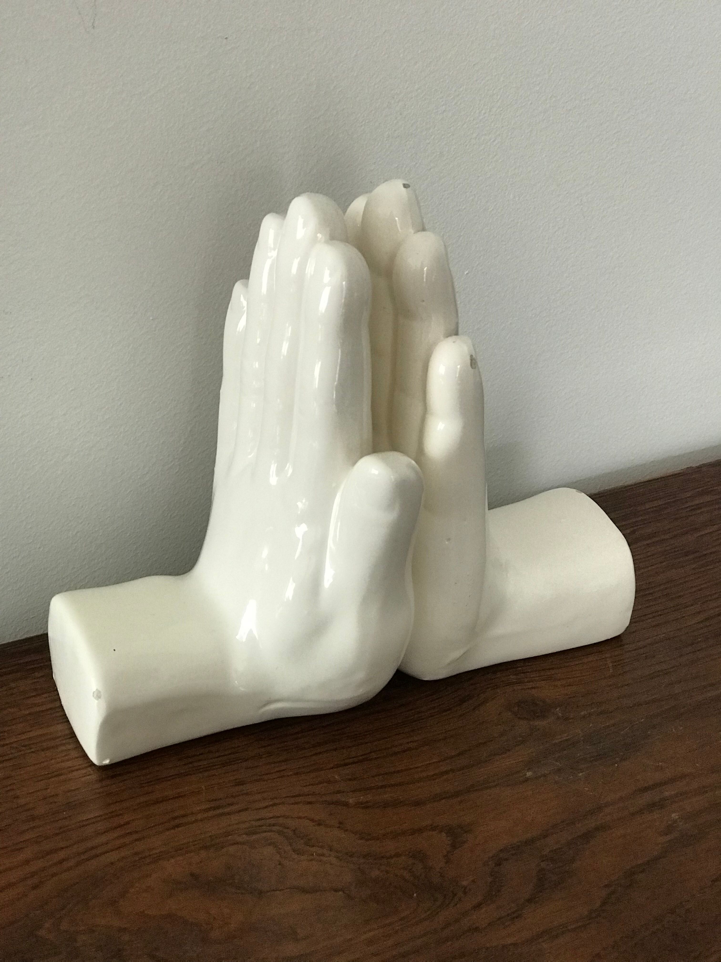 Hands tighten books in ceramics