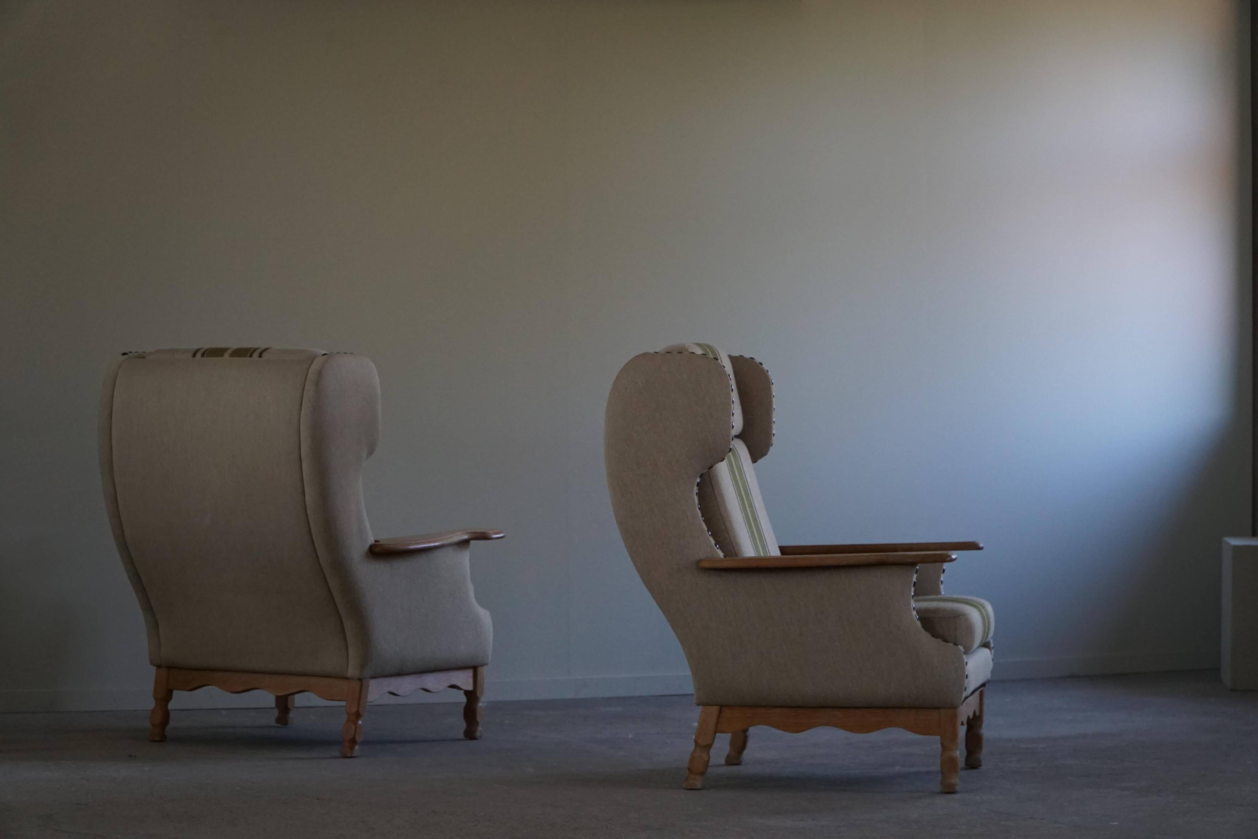 Pair of high-back lounge chairs in modern Danish style in the manner of Henning Kjærnulf, 1960s.