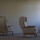 Pair of high-back lounge chairs in modern Danish style in the manner of Henning Kjærnulf, 1960s.