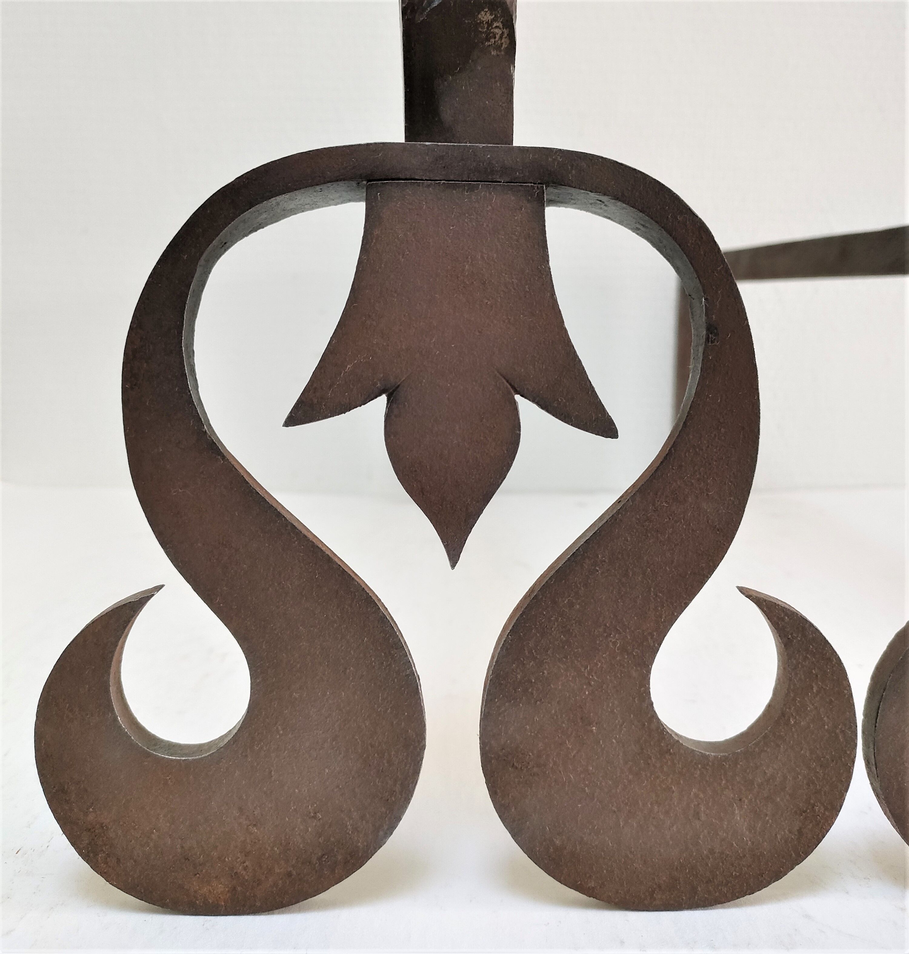 Pair of sculptural cast iron chenets with twisted heads