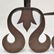 Pair of sculptural cast iron chenets with twisted heads