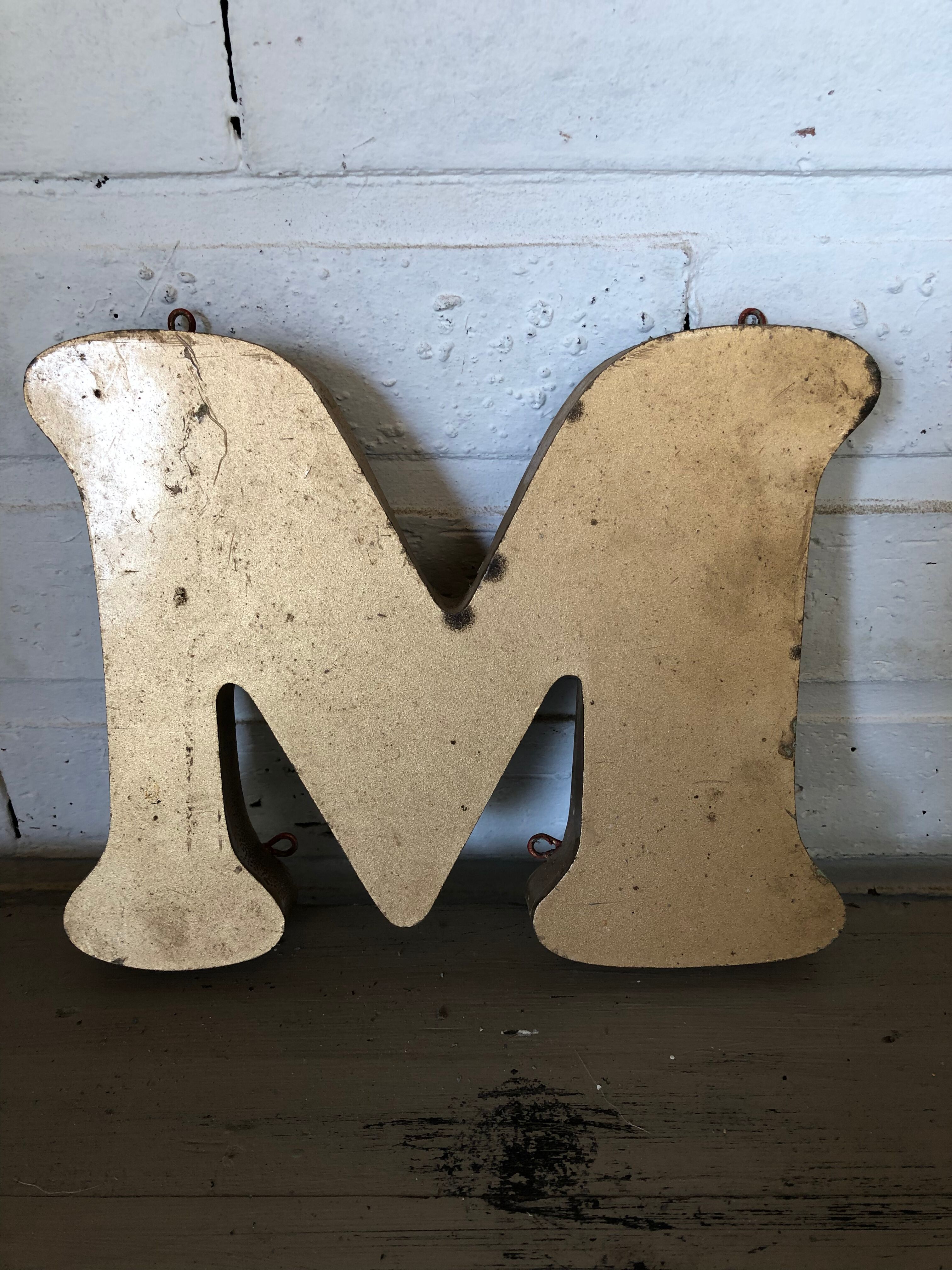 Golden sign letter "M"