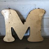 Golden sign letter "M"