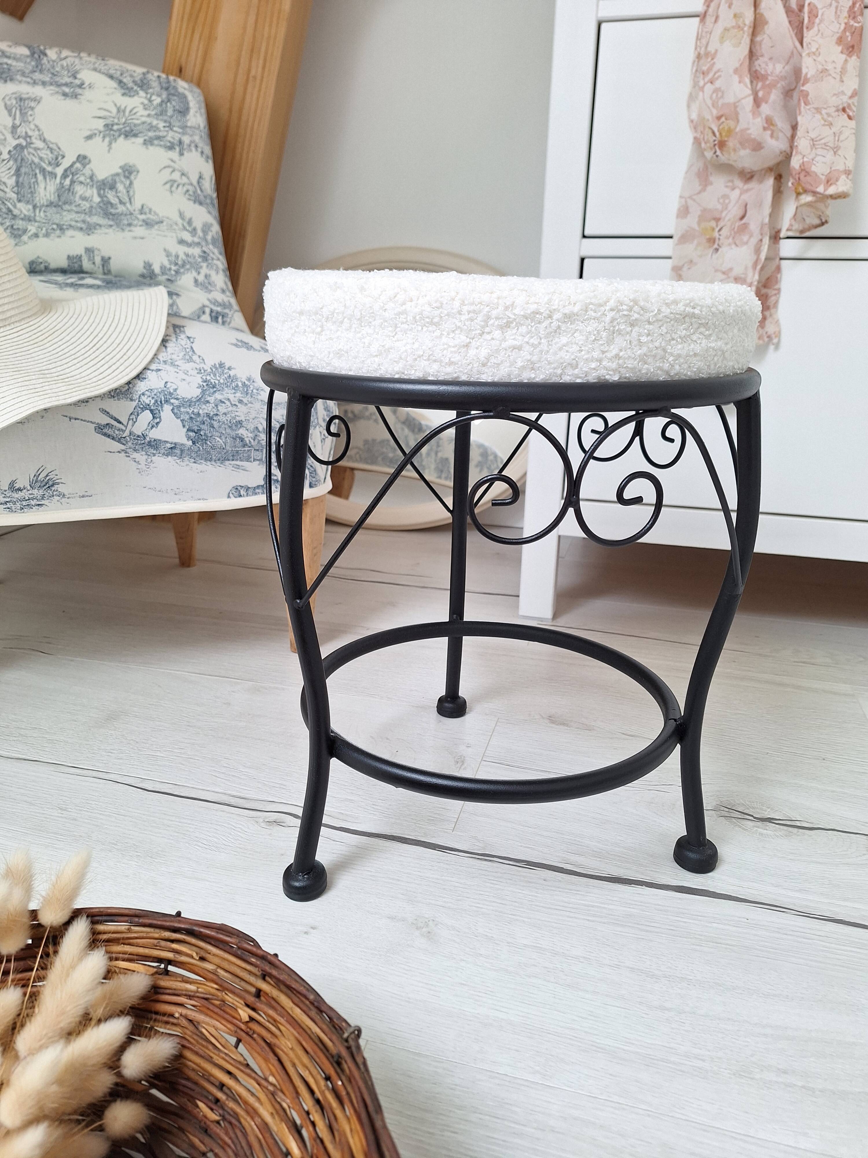 Black iron stool/pouf with its boucle fabric cushion.