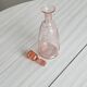 Antique translucent pink glass bottle