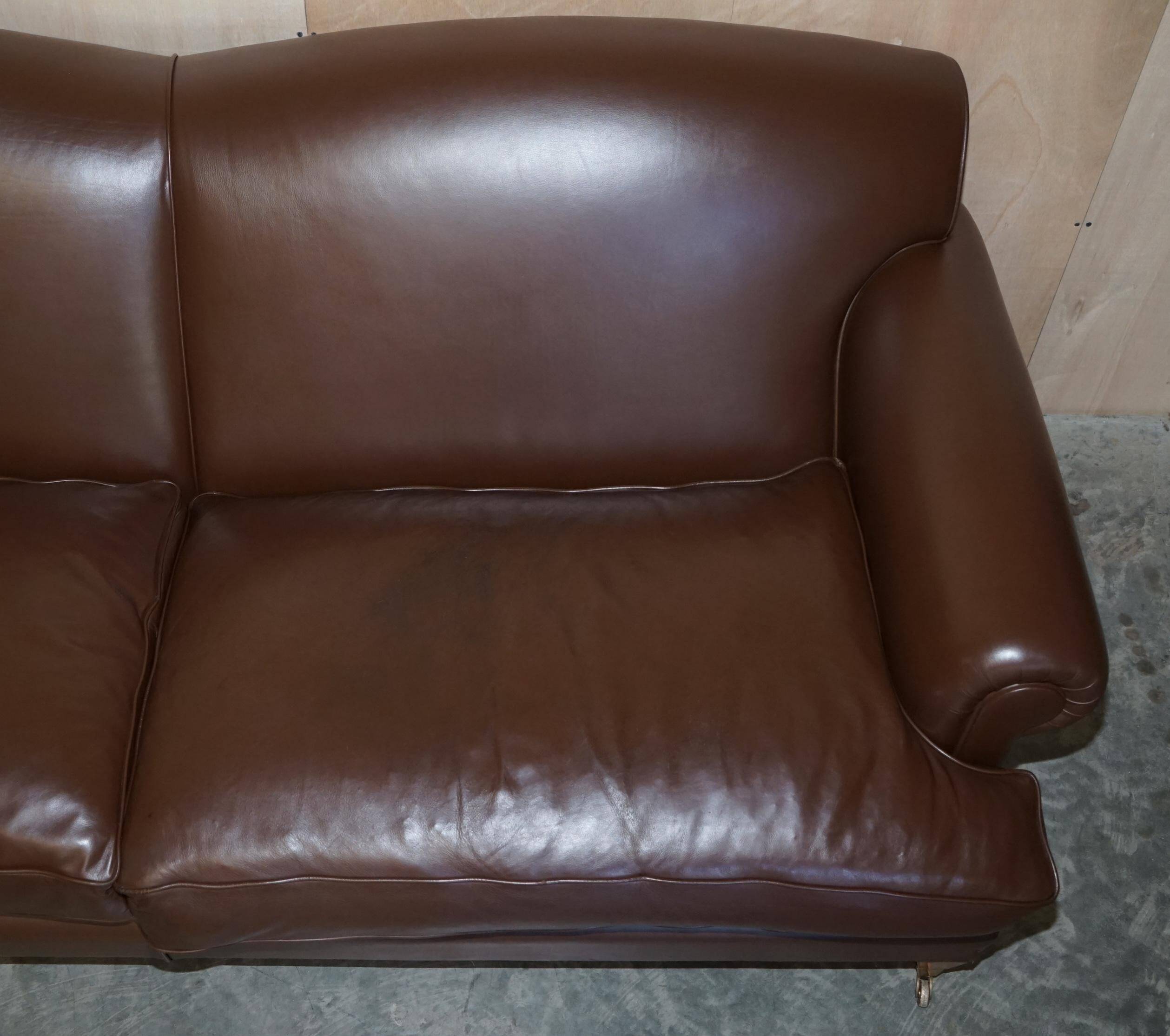 Contemporary Howard & Sons style grand sofa with brass casters.