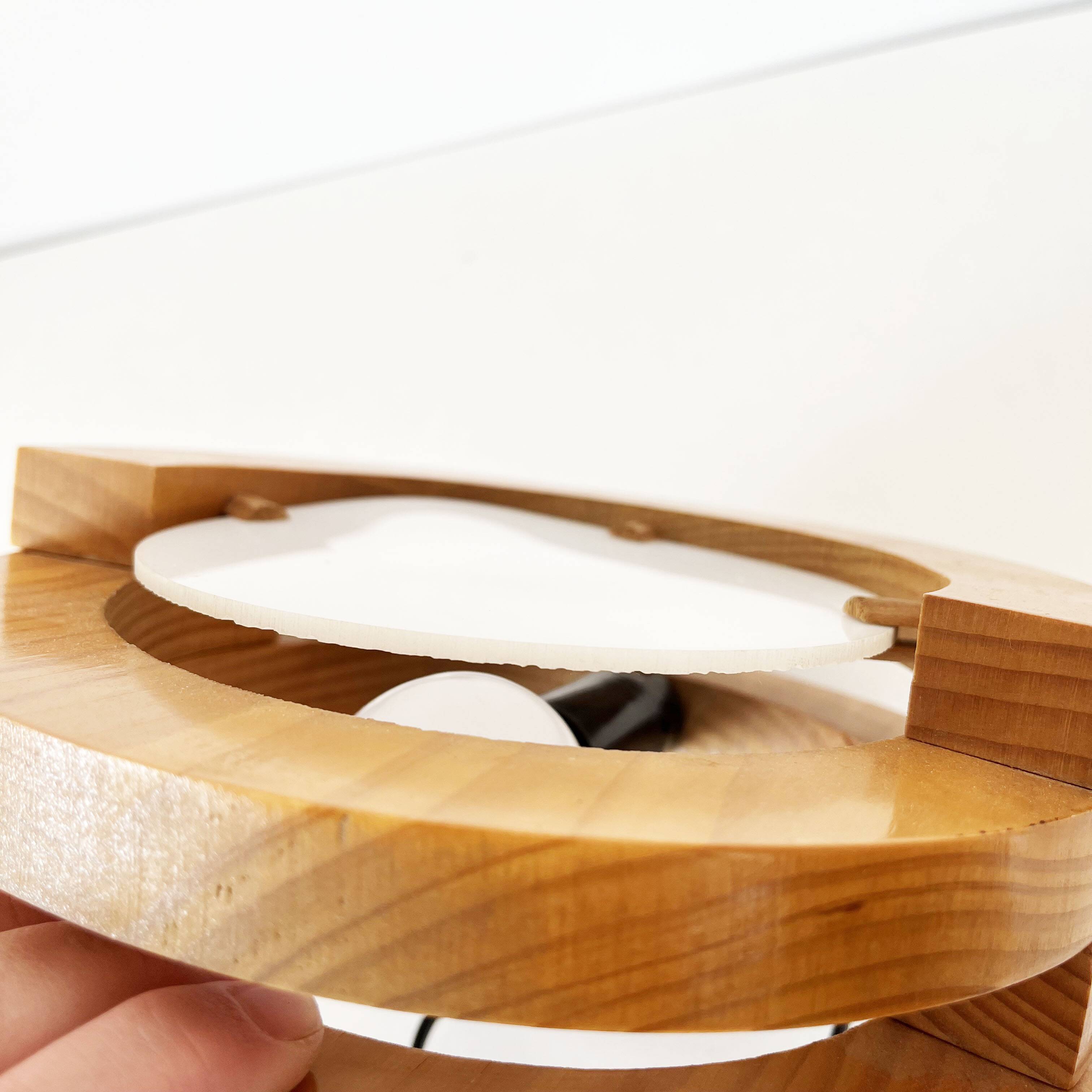 Round pine and plexiglass wall light, 1970s