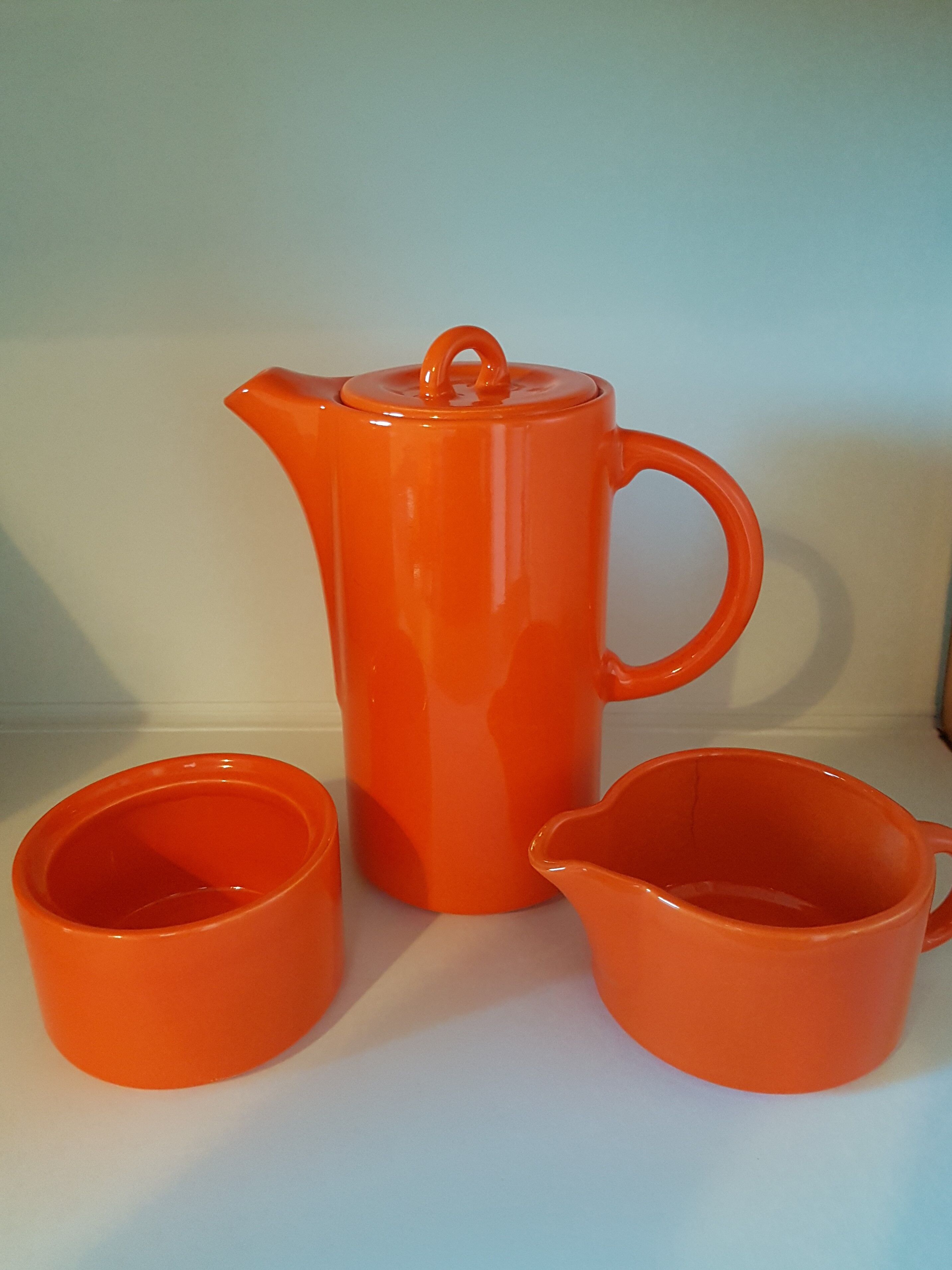 Coffee pot has orange 1970 sugar milk
