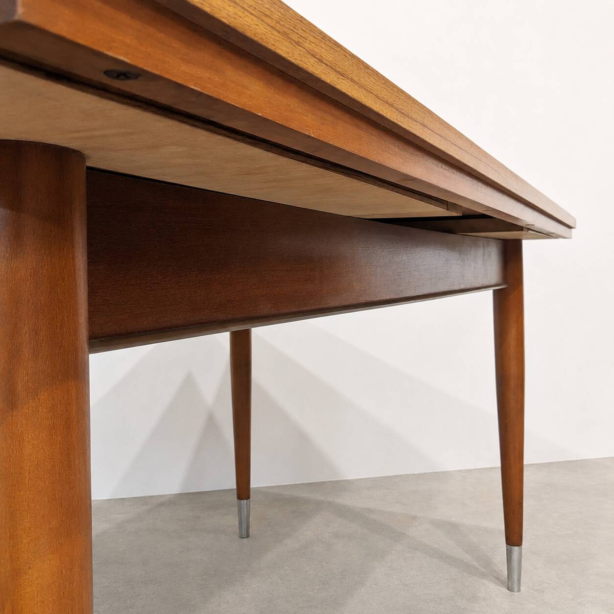 Vintage extendable dining table with tapered legs.