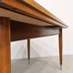 Vintage extendable dining table with tapered legs.