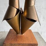 Golden brass sculptural horns on wooden base — modern metal art sculpture, 68.5 cm high