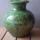 Ancient vase in glazed terracotta with green glaze.