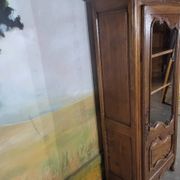 Small oak display cabinet with one door.