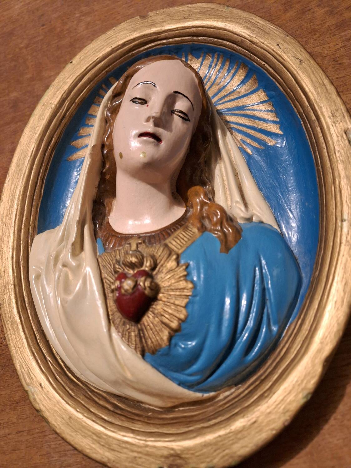 Vintage plaster frame of the Virgin, old religious painting