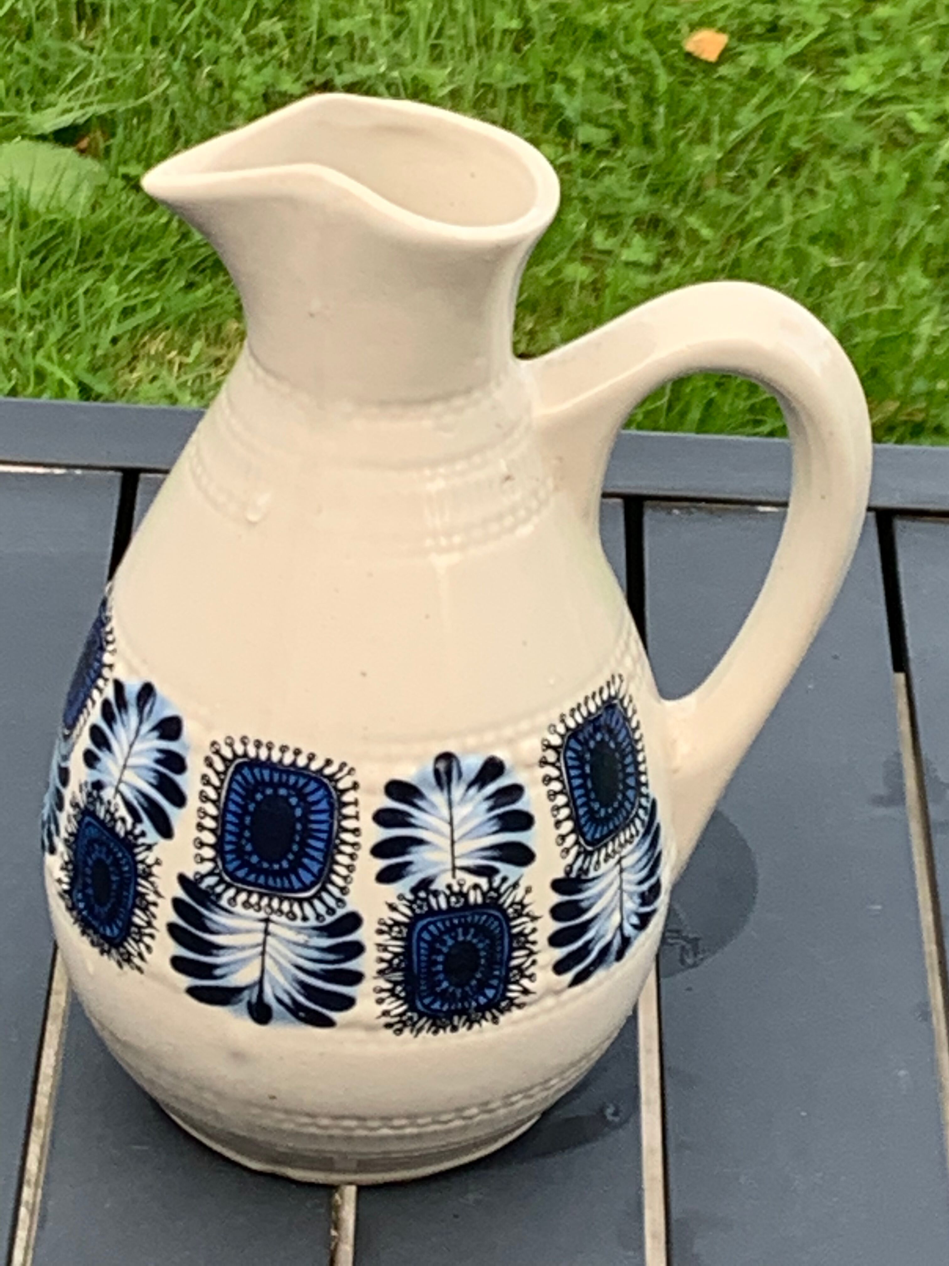 Enamelled sandstone carafe with a nice pattern of vintage blue flowers and 1970 design