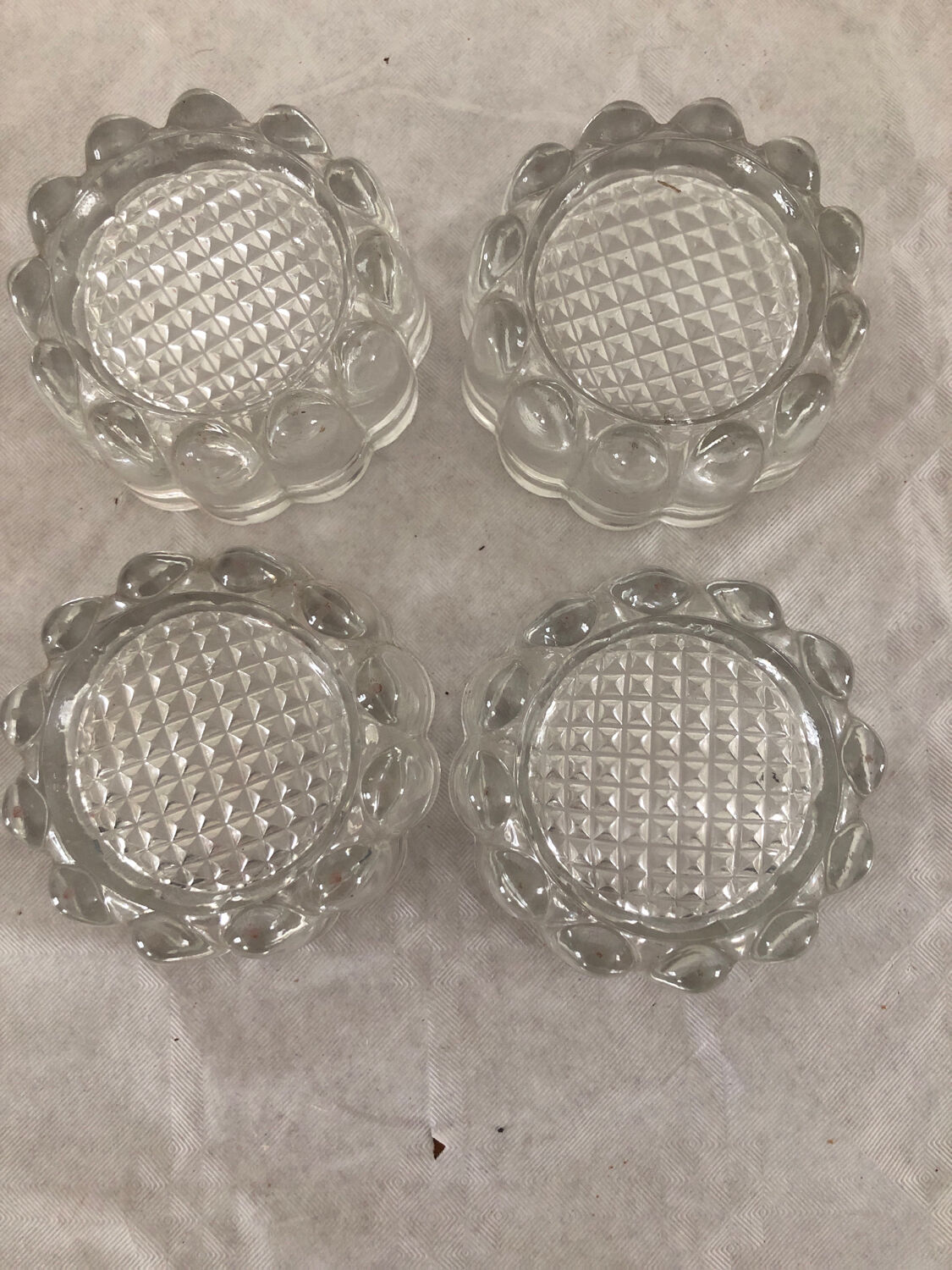 4 flat glass candle holders cut in the shape of Vintage flowers