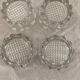 4 flat glass candle holders cut in the shape of Vintage flowers